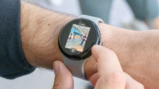 The Google Pixel Watch 3 on a user's wrist showing the live feed from a Nest camera