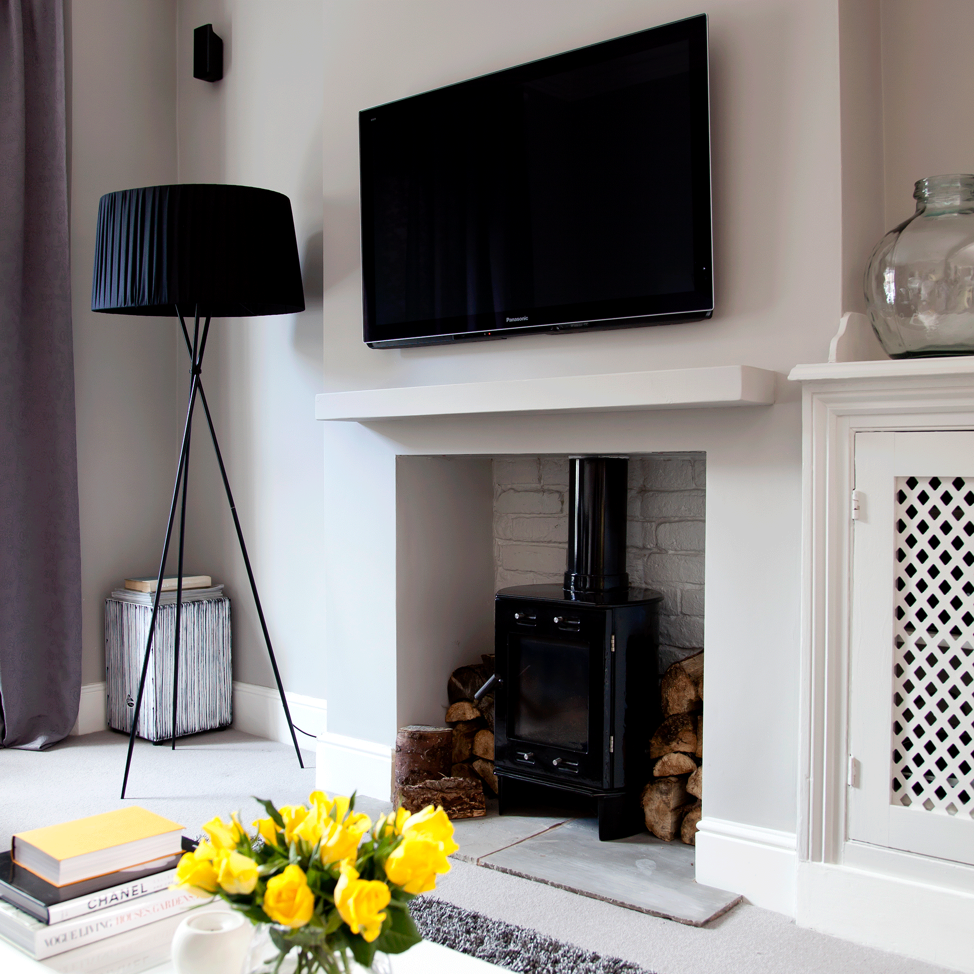TV over the mantle in a grey living room
