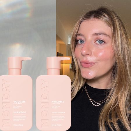 samantha holender with blonde fine hair taking a selfie in her apartment next to two pink shampoo and conditioner sets