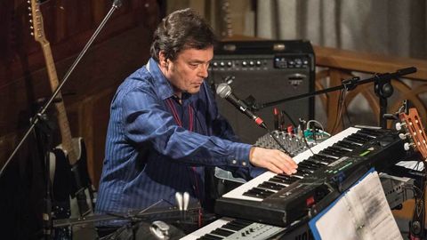 John Hackett playing keyboards in a church