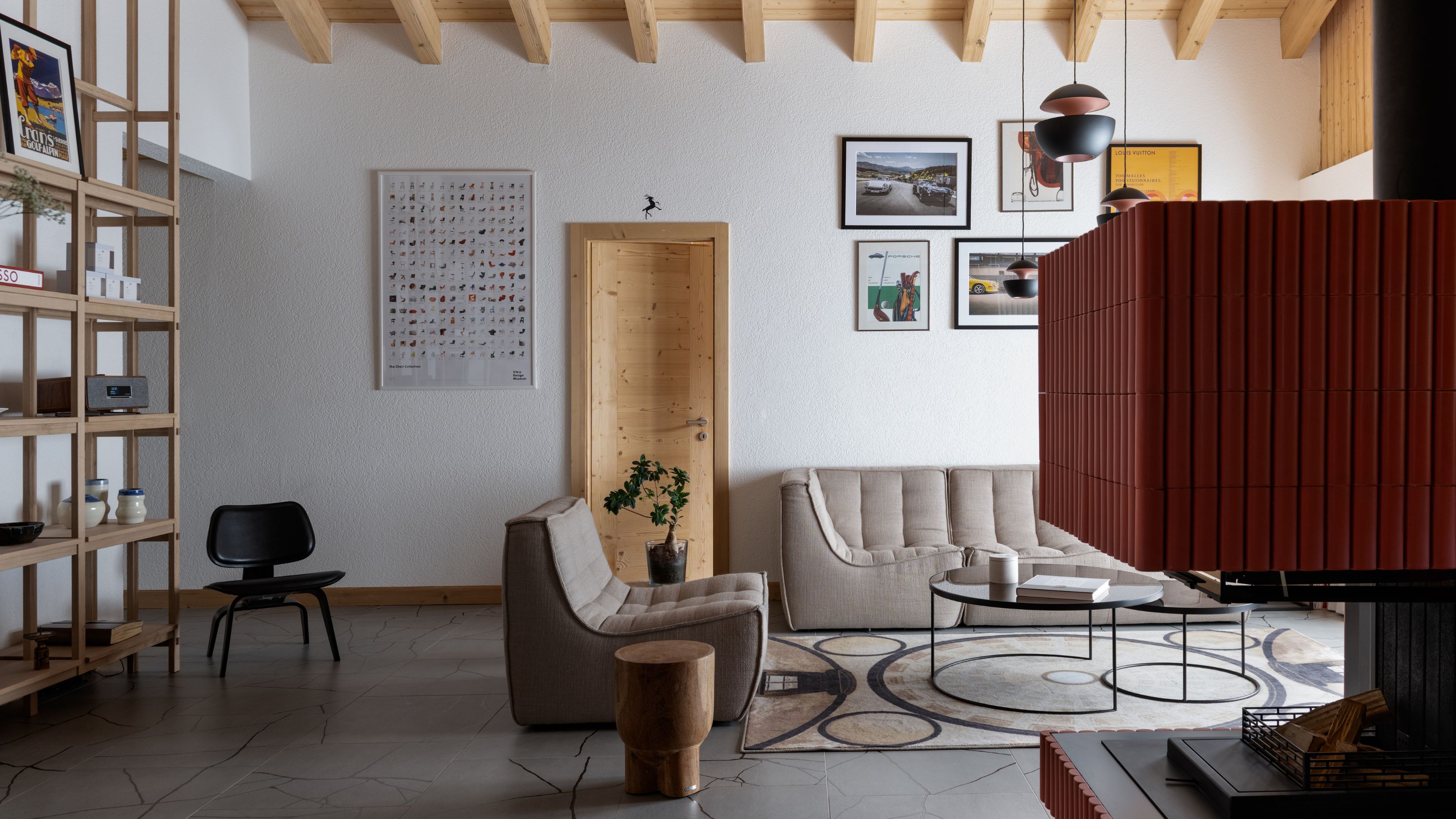 A modern, minimalist living room with exposed wood beams and two boneless sofas.