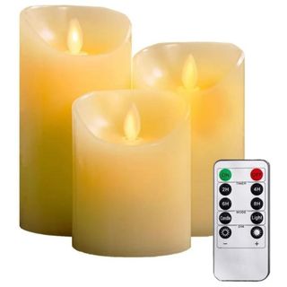 Three ivory coloured flameless candles with a remote.