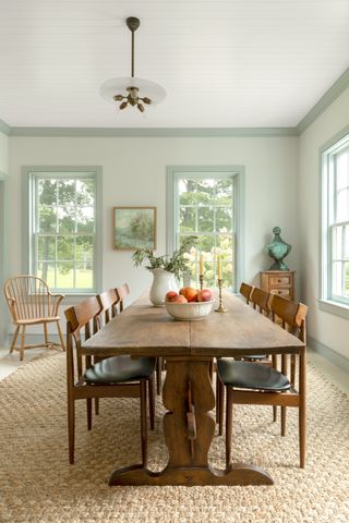 Pale green dining room with wooden furniture