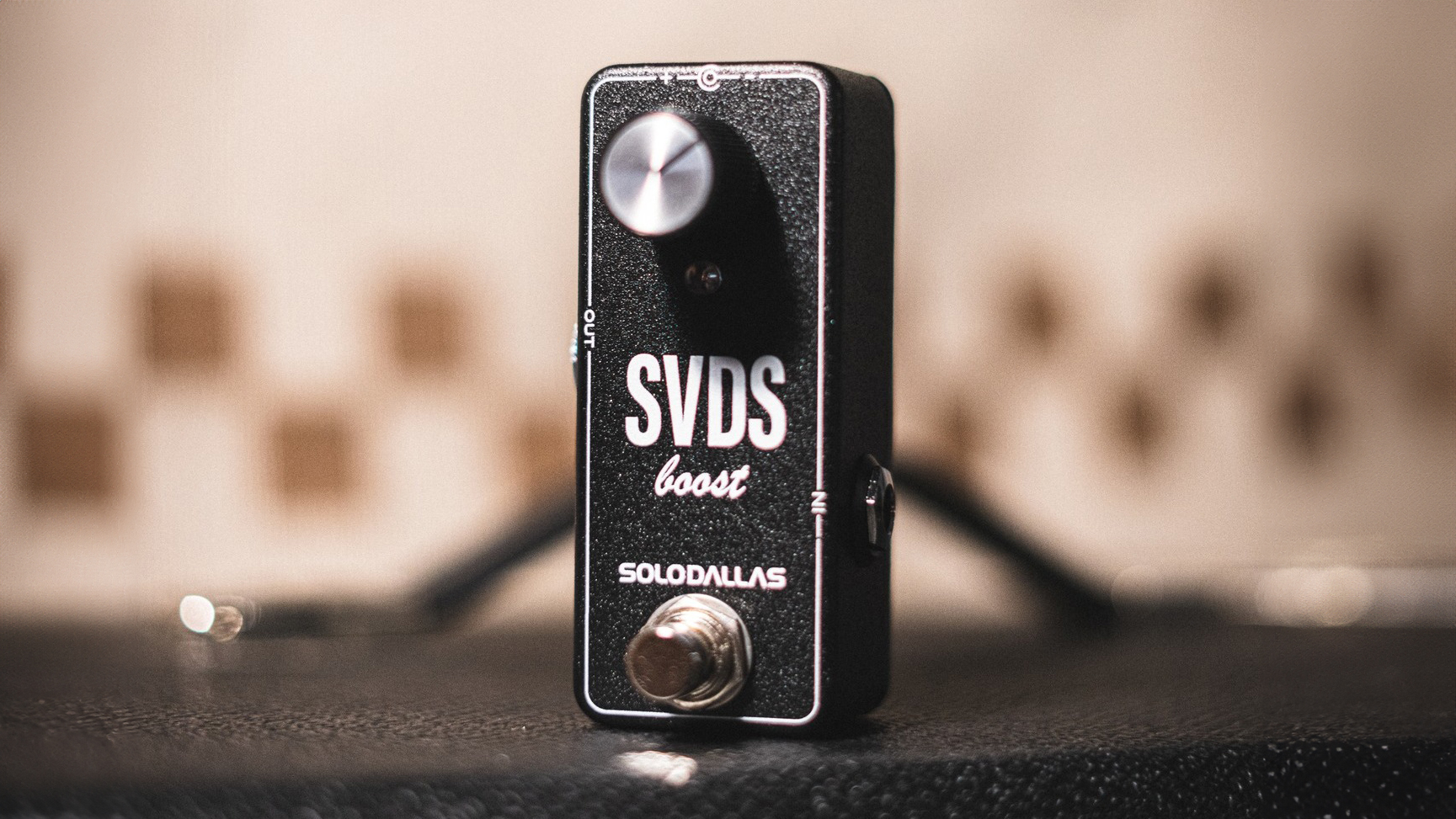 SoloDallas SVDS Boost pedal on top of a guitar amp