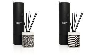 Two reed diffusers with black packaging. The left has a fan design and the right has spots and stripes