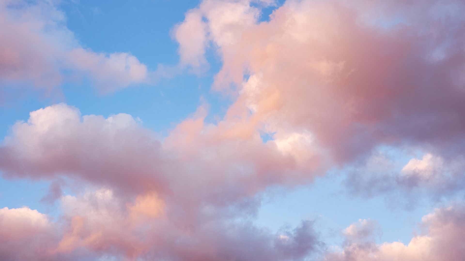pink clouds in blue sky representing Vāta dosha (air + ether)
