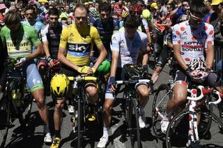 Chris Froome and the other riders respect a minutes silence before the start of stage 14