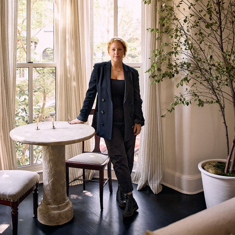 Blair Moore standing in neutral living room by a bay window
