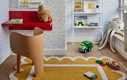 a small kids bedroom with toys on the floor