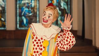 Deborah waves while dress as a clown
