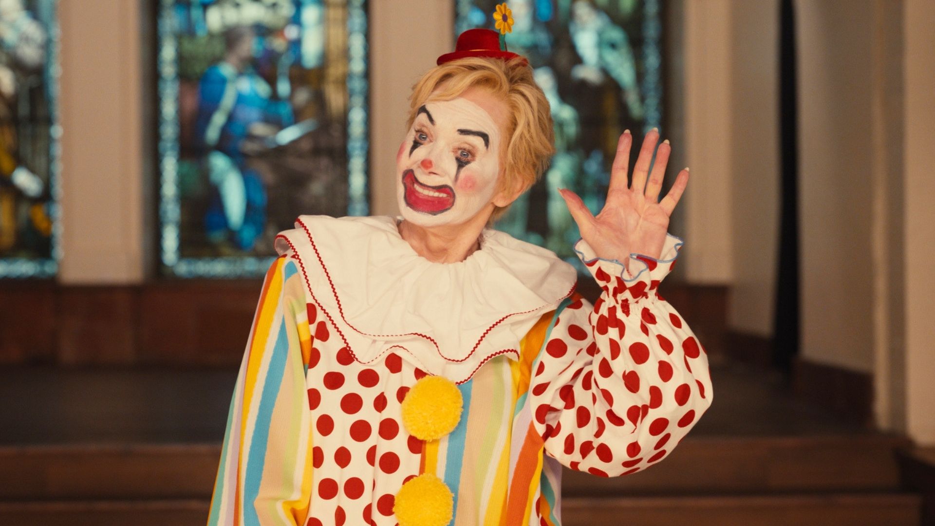 Deborah waves while dress as a clown