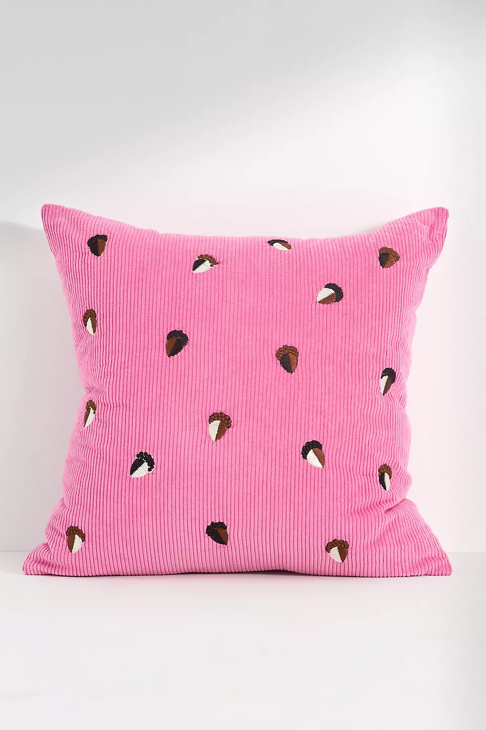Pink throw pillow with acorns