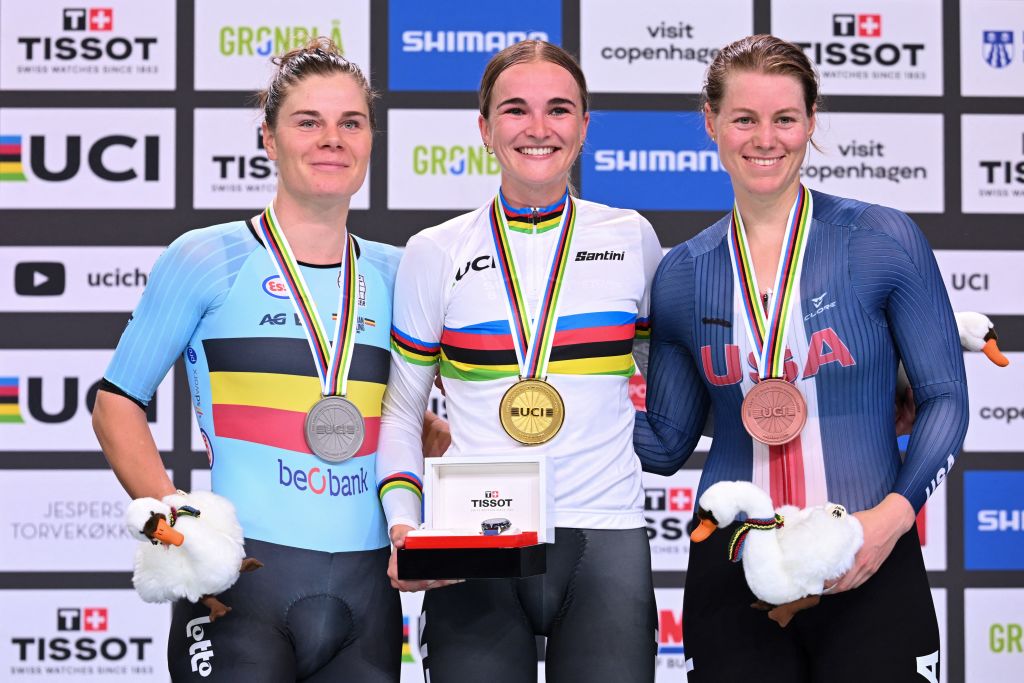 (LtoR) Second placed Belgium's Lotte Kopecky, winner New Zealand's Ally Wollaston and third placed US' Jennifer Valente celebrate on the podium after the women's elimination race of the UCI Track Cycling World Championships in Ballerup, Denmark, on October 17, 2024. (Photo by Jonathan NACKSTRAND / AFP)