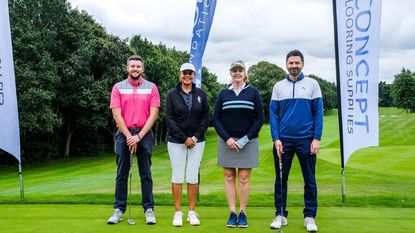 Golfers pose for a picture on the 1st tee at a charity day