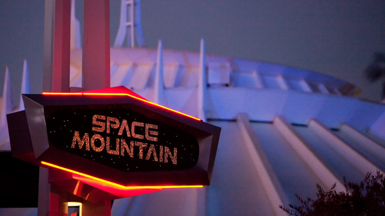 Space Mountain entrance sign at night