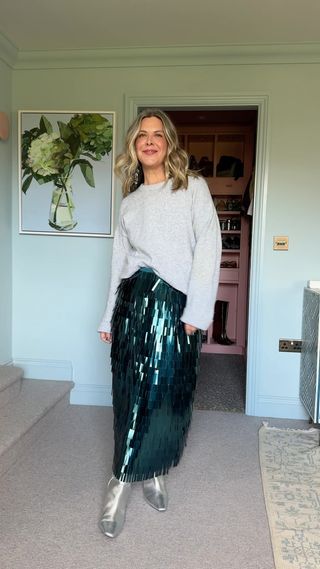 grey jumper worn with a sequin skirt and silver boots