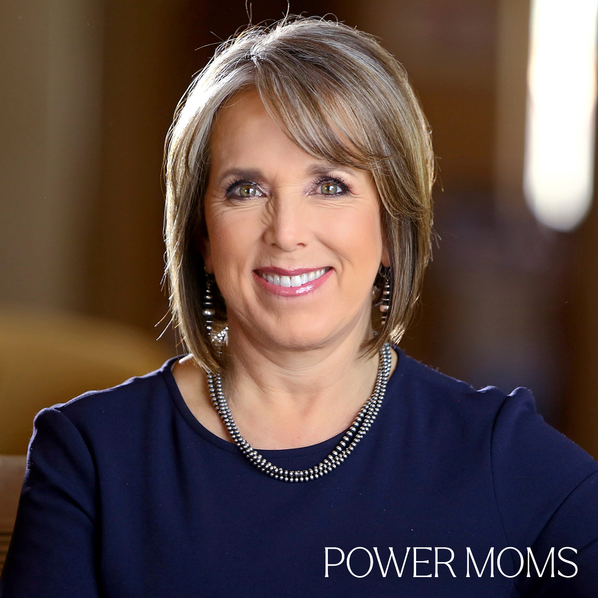 Michelle Lujan Grisham with the text Power Moms overlaid