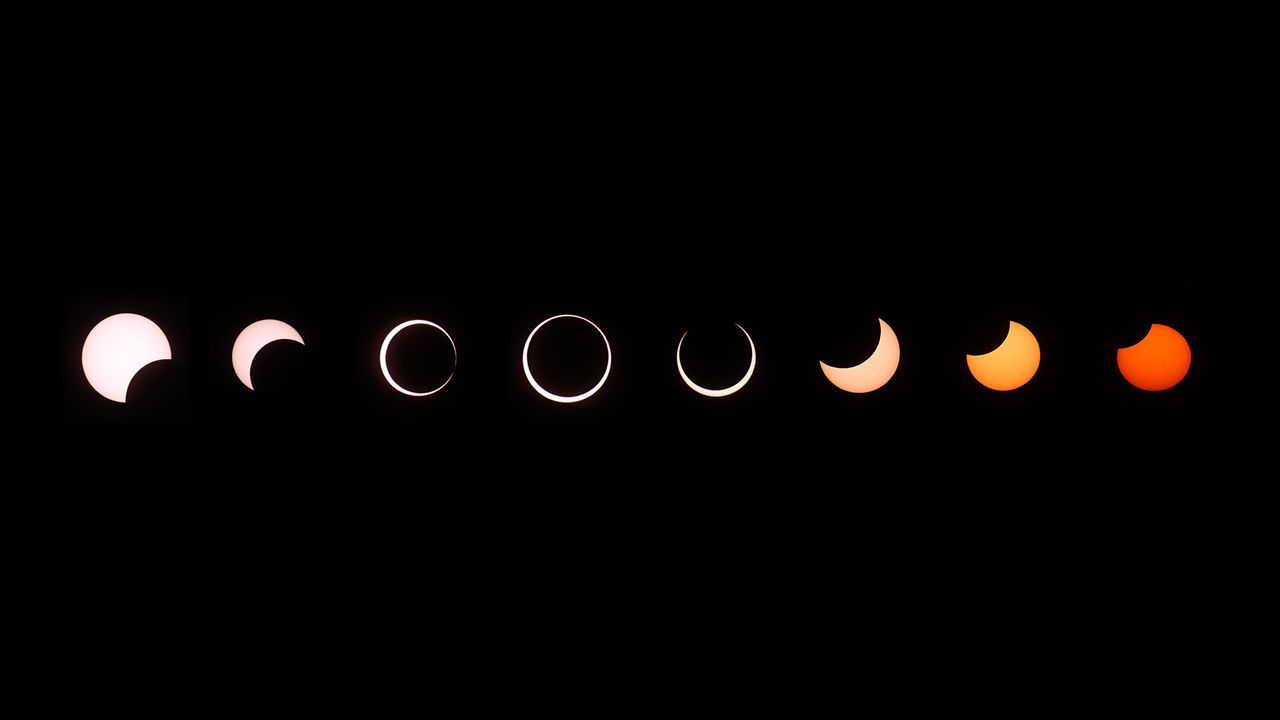A composite of images of an annular solar eclipse shows several stages, left to right, as the moon passes in front of the sun.