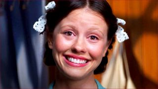 Mia Goth grinning as Pearl