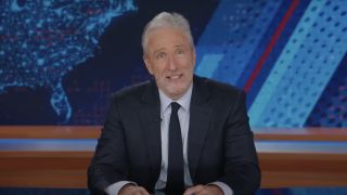 Jon Stewart looking at camera with a perplexed expression