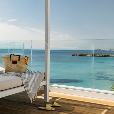 a balcony from villa le blanc hotel overlooking the mediterranean sea in menorca