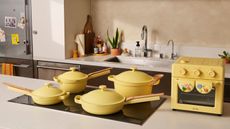 Butter yellow Our Place cookware on induction hob with yellow Wonder Oven beside