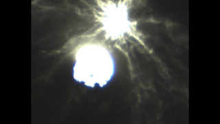 two bright blobs, one surrounded by wispy rays