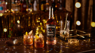 Two Gingerbread Old Fashioned cocktails pictured on a festive table