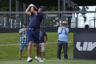 Phil Mickelson teeing off at a LIV Golf event.