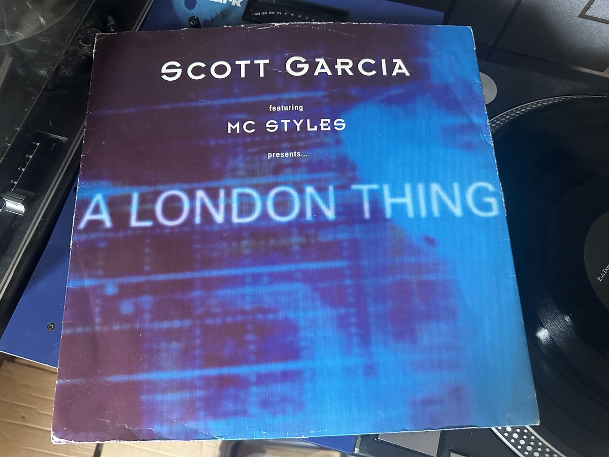 The sleeve of Scott Garcia's A London Thing on vinyl, placed on top of a turntable. The cover is mostly blue.