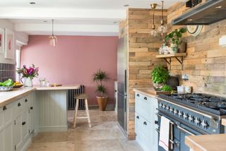 kitchen with blue range cooker and pink feature wall