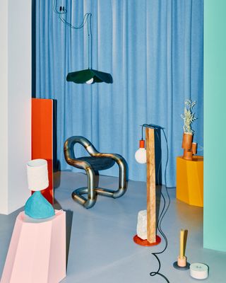 view of interior design items by Atelier100 with blue curtain behind them