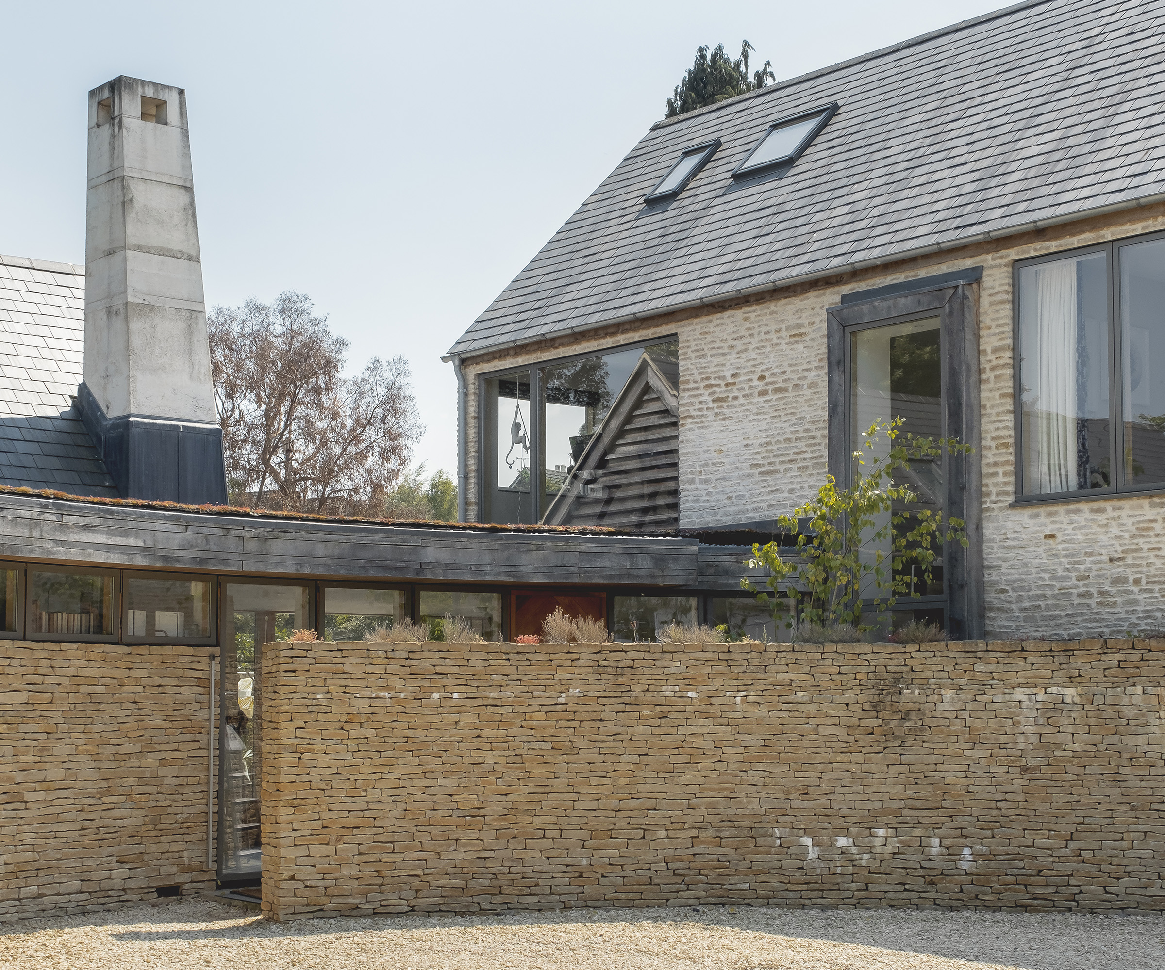 The exterior of a self build with a light brick wall
