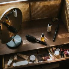 Make-up in the drawer of a wooden dressing table - make-up expiry dates