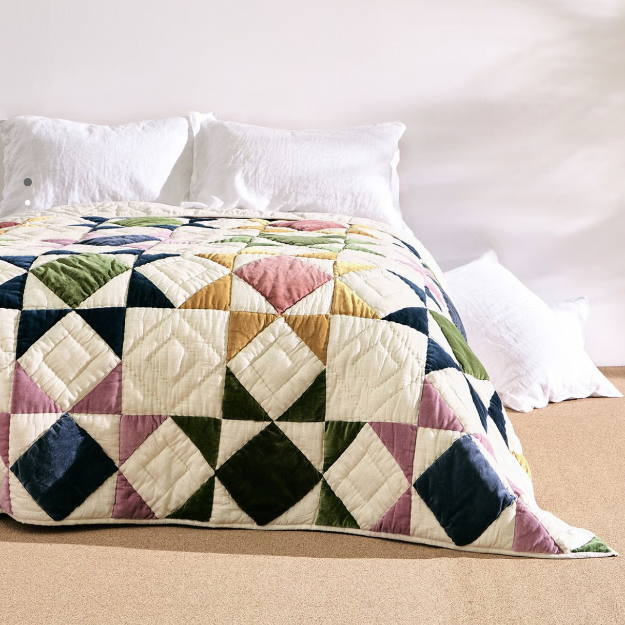 bed with patterned quilt