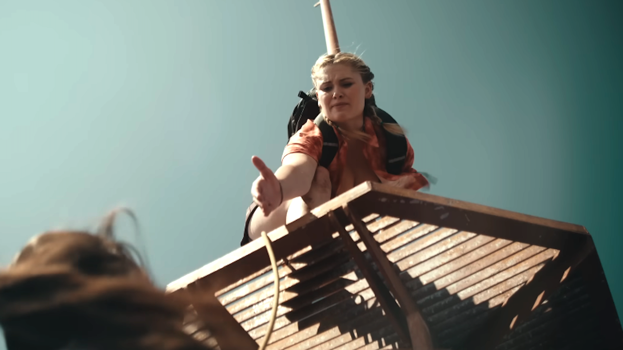 Virginia Gardner holding her hand out in Fall