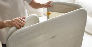 person folding away the fabric cover of the new Joseph Joseph Eclipse clothes airer