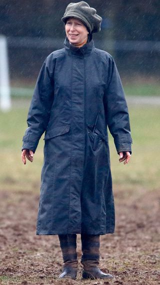 Princess Anne, Princess Royal stands in the rain in a muddy field as she attends the Gatcombe Horse Trials at Gatcombe Park on March 25, 2006