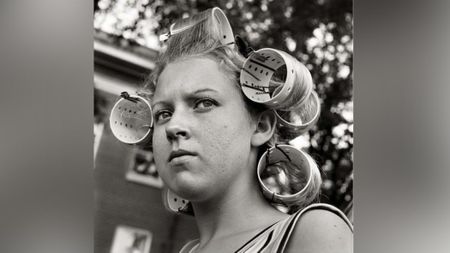 Woman wearing hair curlers.
