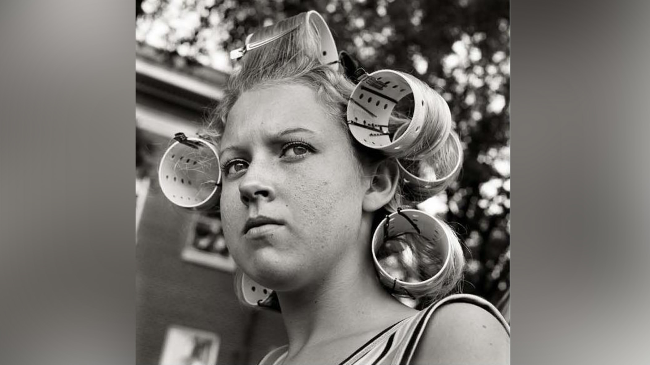 Woman wearing hair curlers.