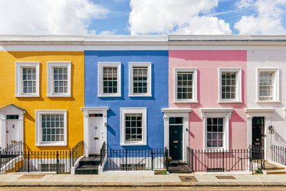 View of houses in vibrant pink, blue and yellow