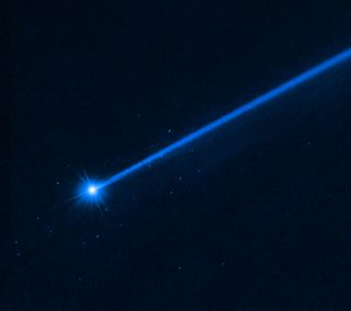 A streak of blue glowing light is shown against a dark background of space. Around the streak are spots representing the boulders.