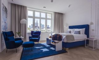 White guestroom with royal blue accents