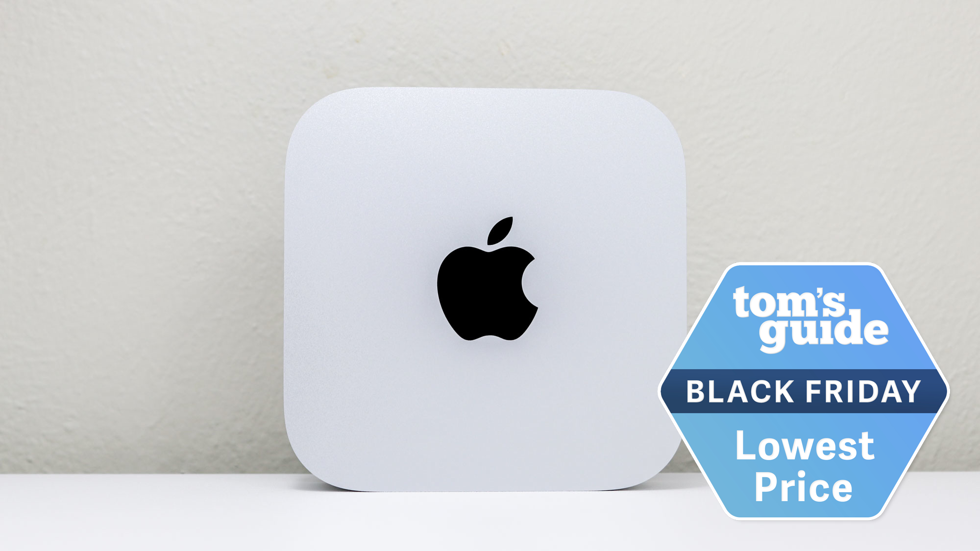 A Mac mini M4 upright on a desk with a Tom's Guide Black Friday deals badge