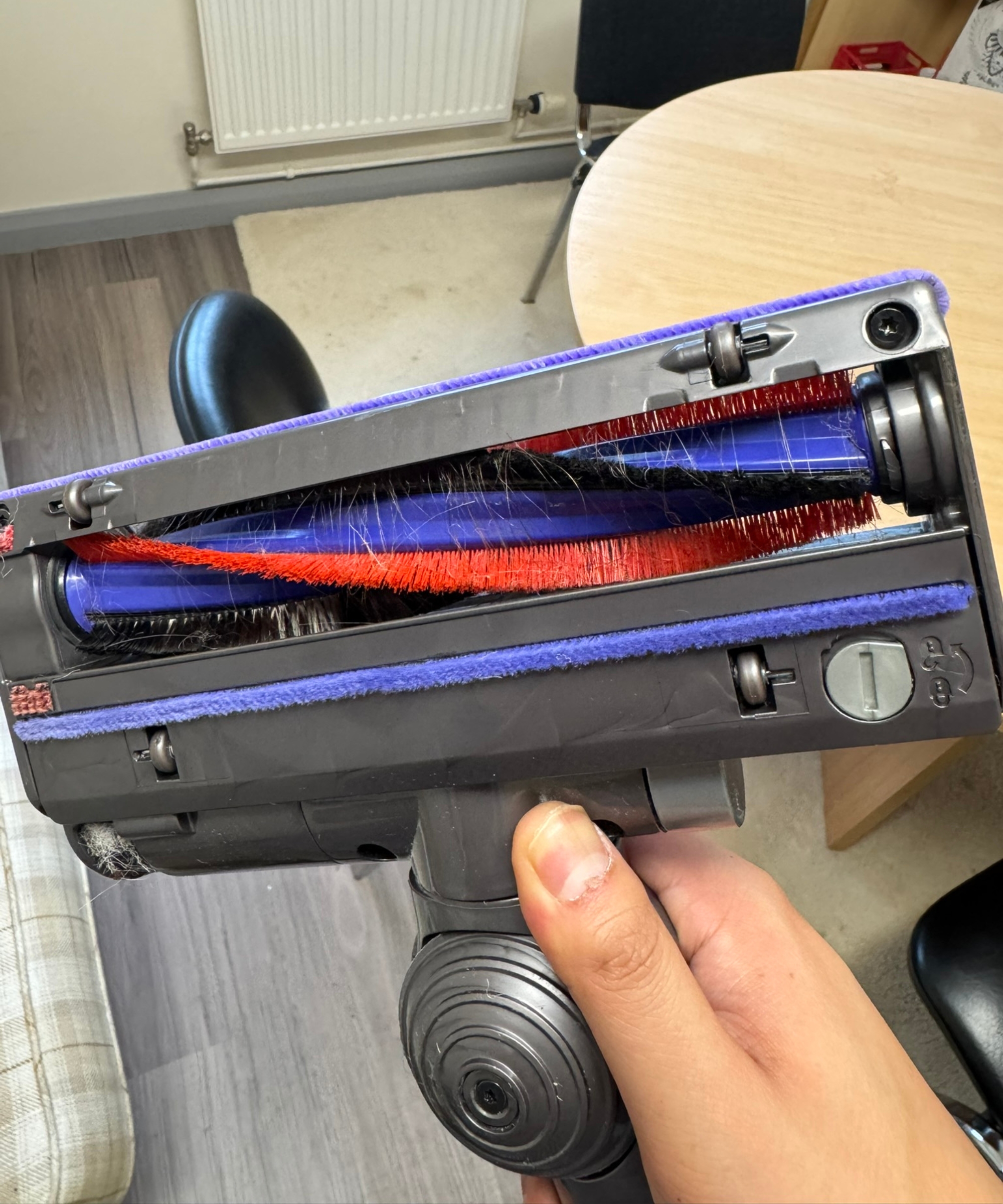 Hand holding the Dyson Big Ball Turbinehead floorhead with pet hair visible in brushroll in Bristol ARC.