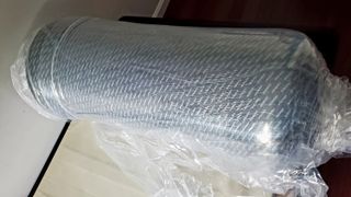 The Tuft & Needle Mint Hybrid mattress rolled and vacuum-packed