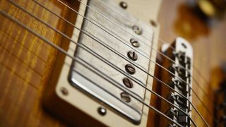 Close up of an electric guitar bridge and electric guitar bridge pickup