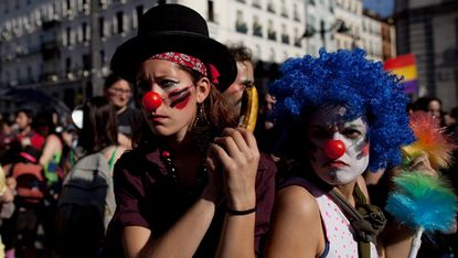 MADRID, SPAIN - MAY 15:Demonstrators with Spain's Indignant movement dressed as clowns perform as policemen during a rally at Puerta del Sol on May 15, 2012 in Madrid, Spain. Spain's Indignan