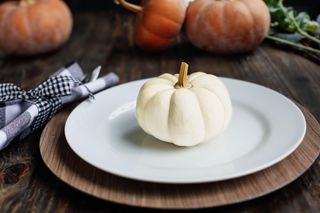 plate with white pumpkin on top
