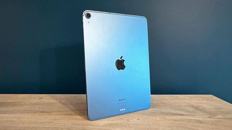 iPad Air 2022 on wooden table with blue background